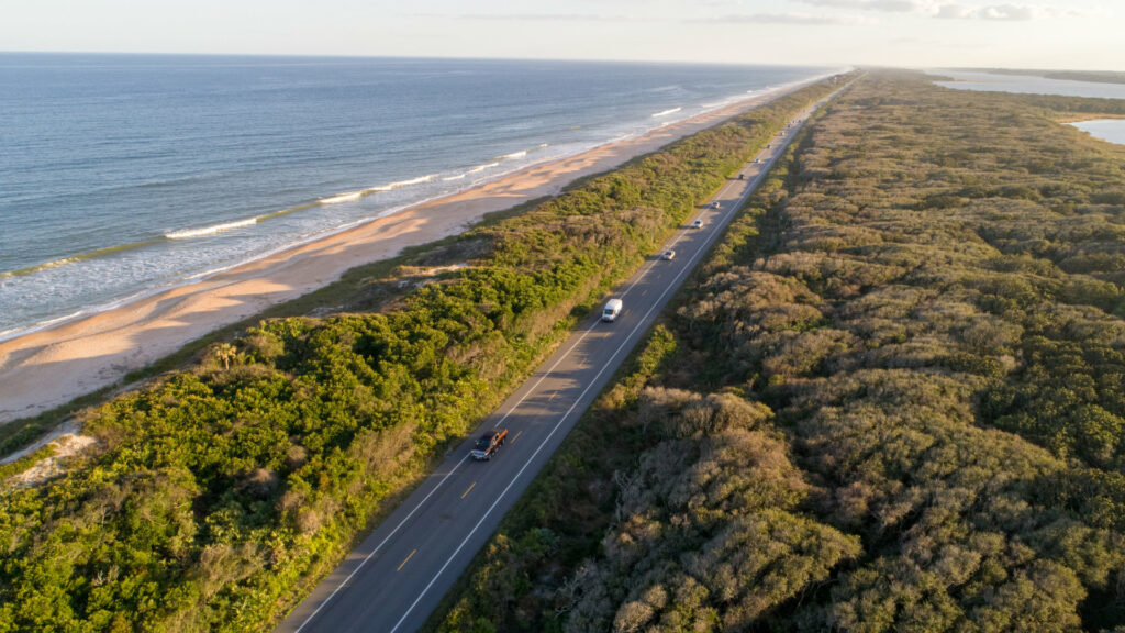 Florida highway with the ocean on one side with trees on the other side